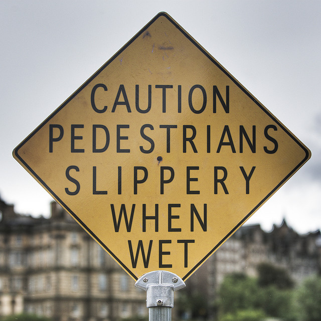 Funny sign: Caution pedestrians slippery when wet sign