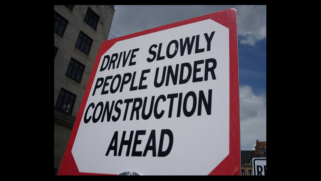 funny sign - drive slowly people under construction ahead