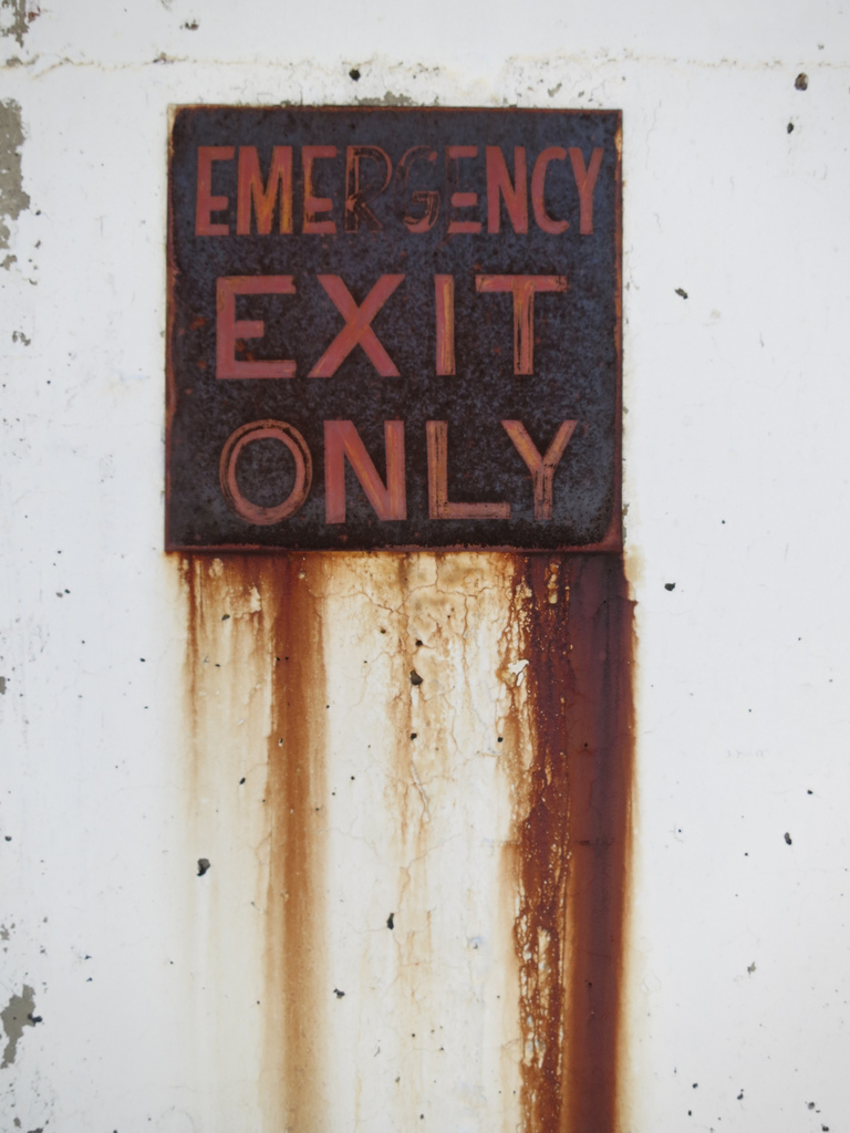 Emergency exit signs should be much more visible than this one. From Paul Sableman. 